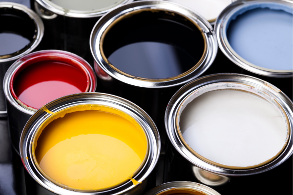 Open cans of colorful house paint including yellow, red, black, white, and blue Open cans of colorful house paint including yellow, red, black, white, and blue