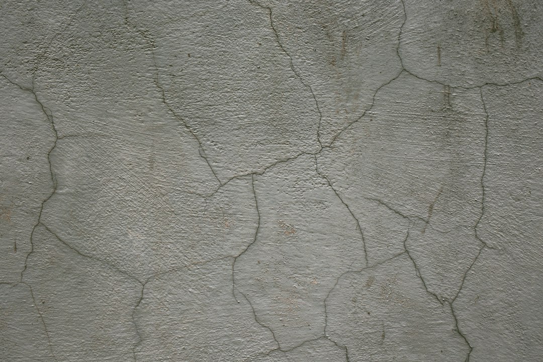 Hairline cracks in an older plaster wall being prepped for painting